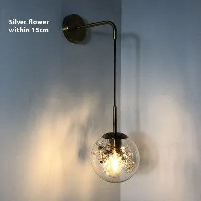 Modern glass wall lamp in golden flower finish, 20cm diameter, mounted on wall