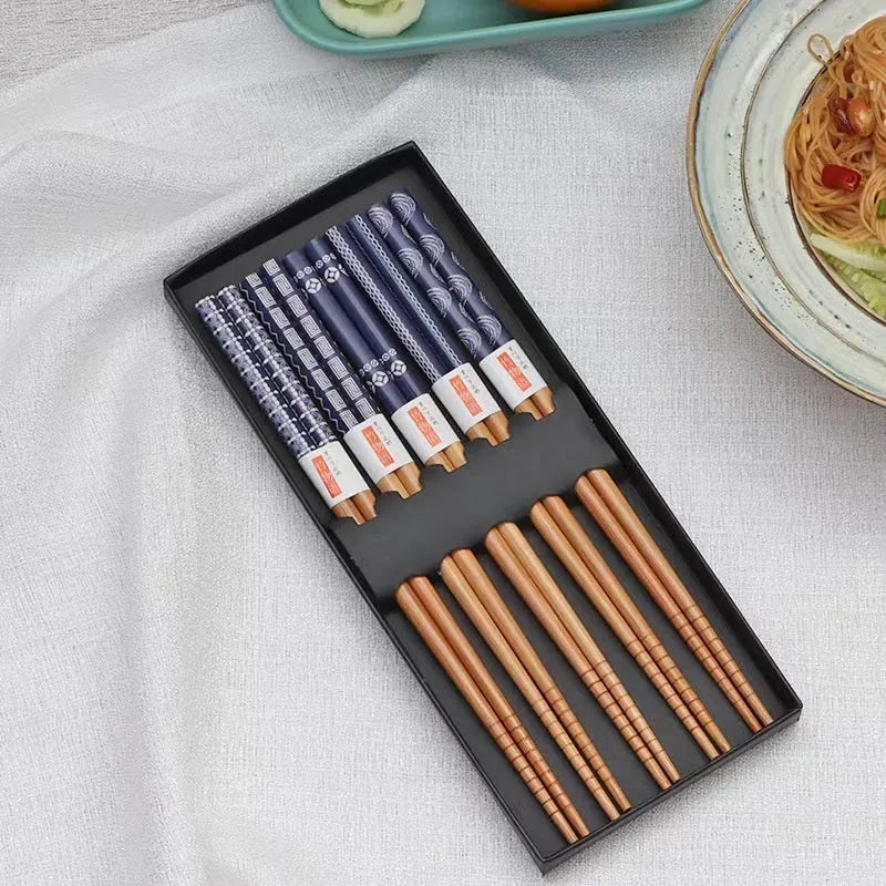 Set of five pairs of bamboo chopsticks with colourful lucky cat cartoon pattern.