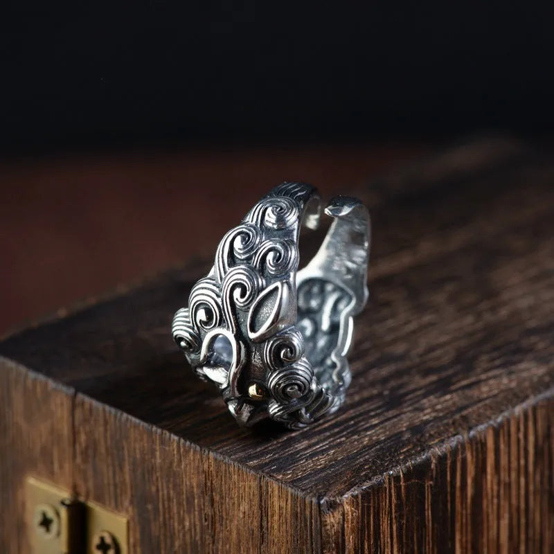 Silver open style ring with detailed jibeast animal pattern and diamond accents