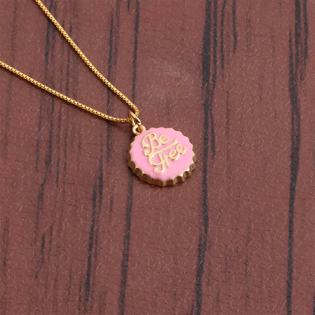 Copper bottle cap pendant necklace with 18k gold electroplating on a box chain, shown in one of six available colours.