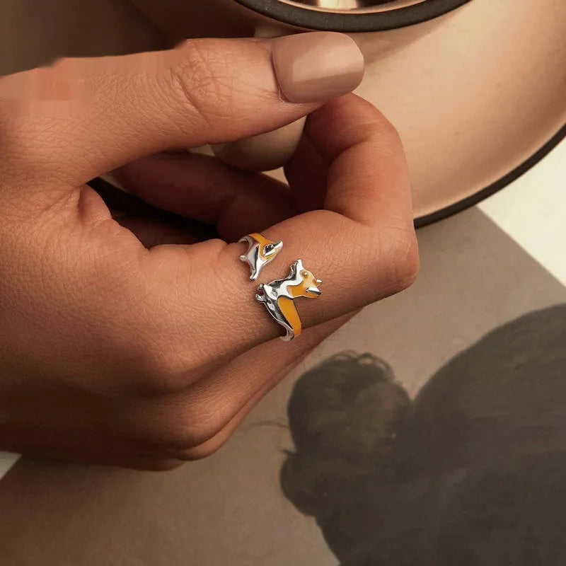 Silver ring with a raised cartoon corgi dog design and electroplated colour finish.