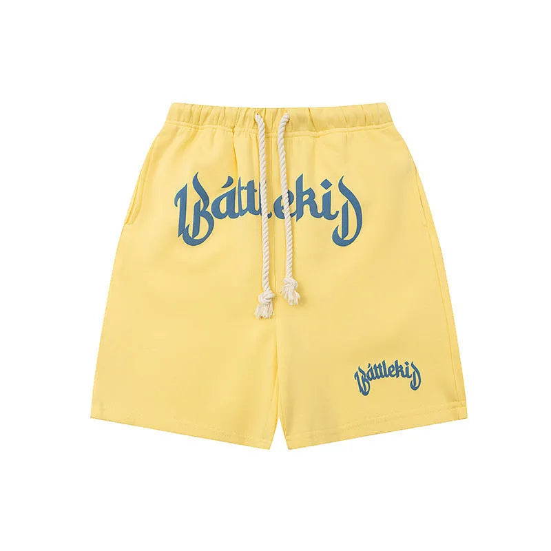 Loose cotton-blend cropped shorts in black, yellow, blue, and grey for street style.