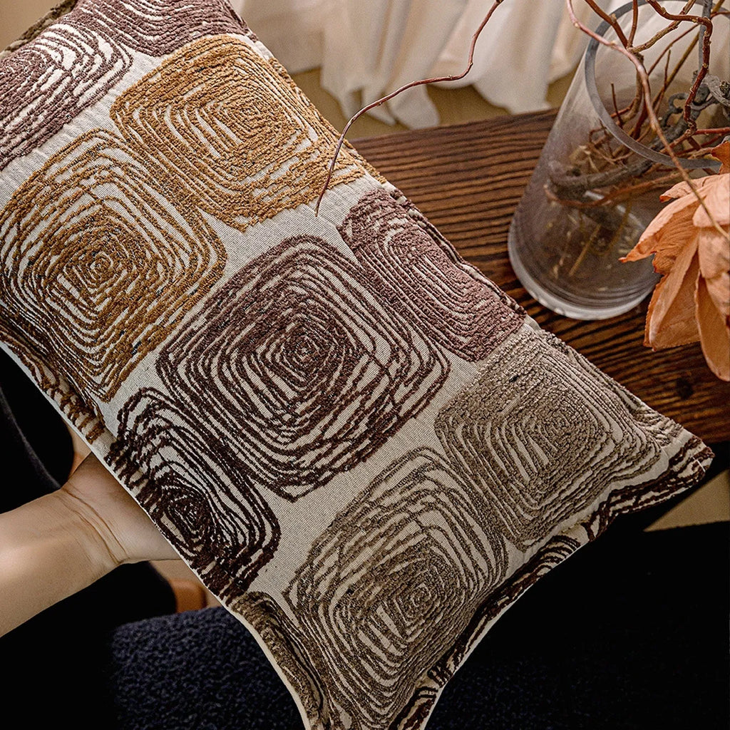 Abstract coil pattern cushion cover in cream and coffee colours, shown in square and rectangular sizes