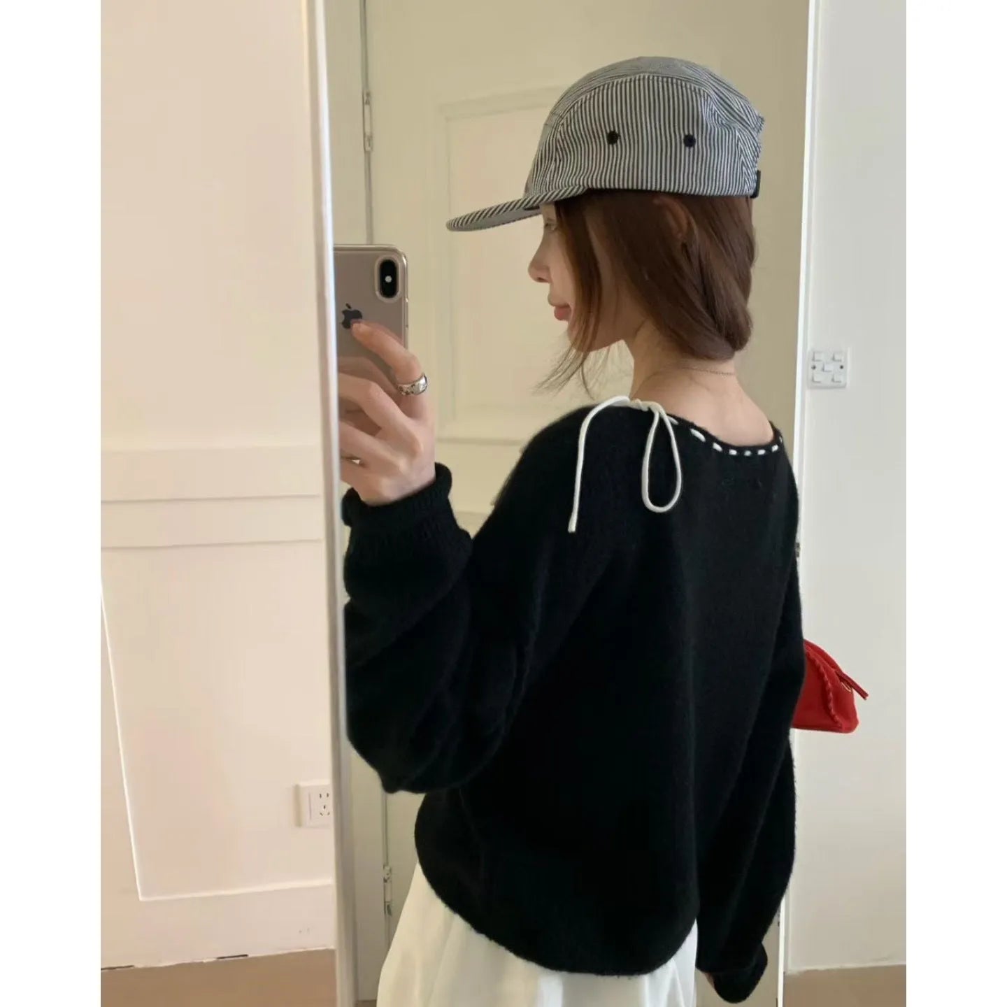 Grey loose-fitting women's knitwear pullover sweater on a hanger