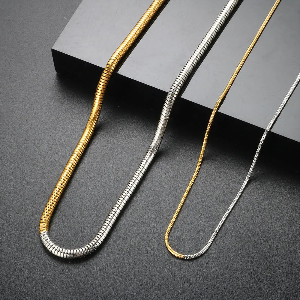 Gold-coloured stainless steel snake bone chain necklace with geometric shapes for women.