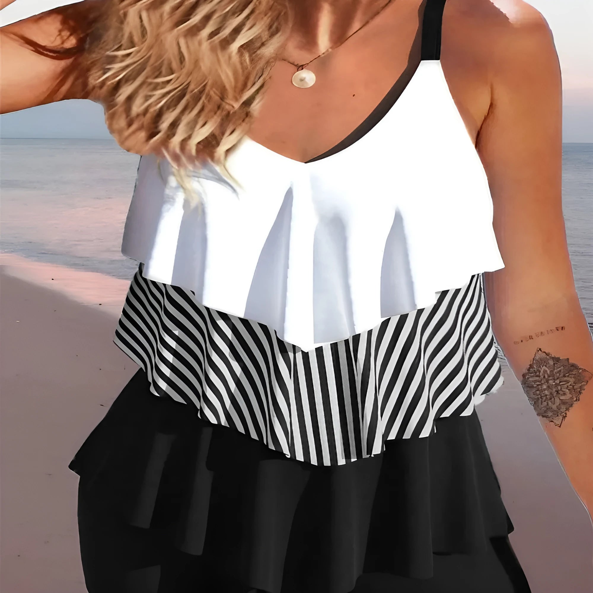 Women's sleeveless backless bikini with spaghetti straps, ruffle detail, and matching split-leg briefs.
