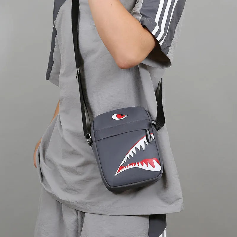 Men's small casual crossbody bag in Oxford cloth, shown in black with adjustable strap and animal print lining visible.