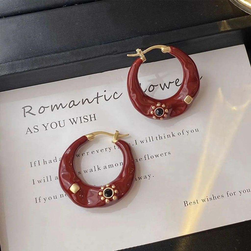 Hong Kong style retro ear studs with dripping oil finish and rhinestone accents in black and red colours