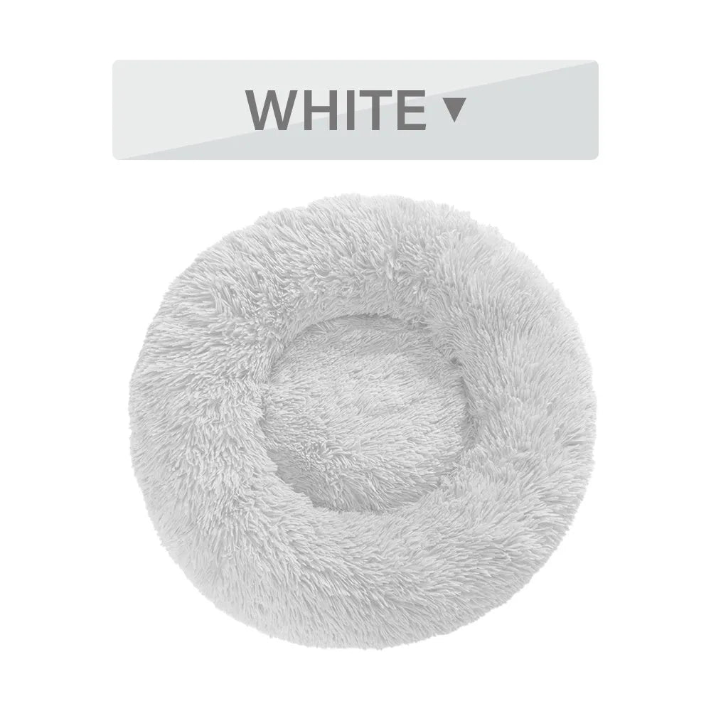 Fluffy donut-shaped dog bed with raised edges in luxury long plush fabric