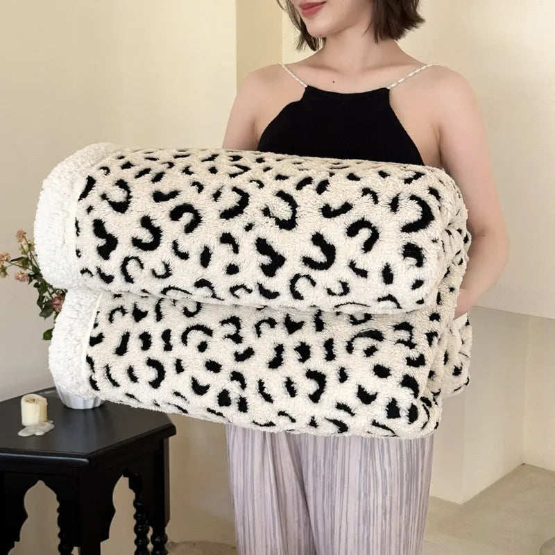 Double-layer cationic jacquard leopard print taffeta blanket in camel colour, folded to show texture.