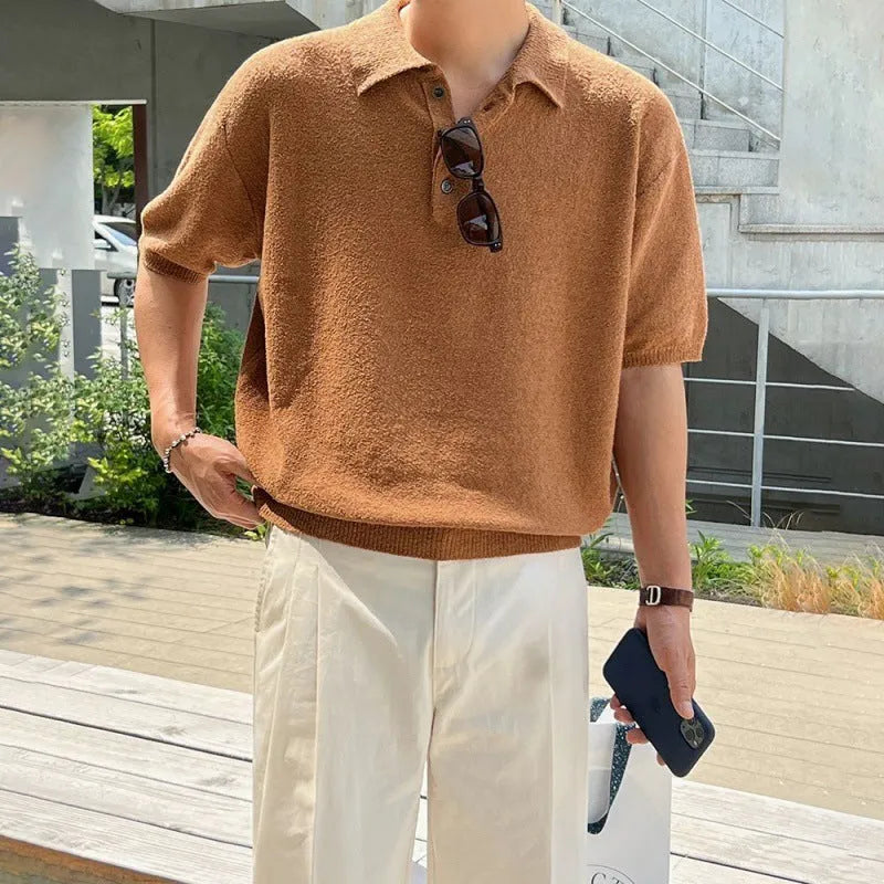 Man wearing a caramel coloured retro knitted polo shirt with short sleeves and an asymmetric design detail.