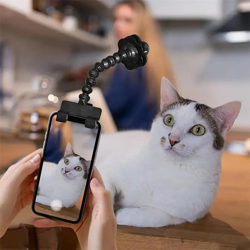 Pet photography selfie stick with clip for snacks in black plastic, showing phone holder and rotatable head