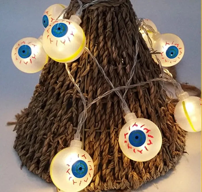 Halloween string lights with pumpkin, bat, and ghost LED lanterns hanging, showing white and coloured light options.