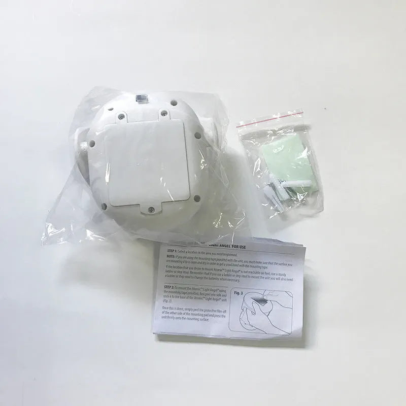 White Atomic Angel induction night light on flat surface with dimensions shown