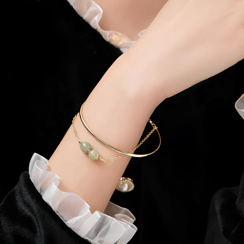 Hetian jade lucky beads bracelet with gold inlay, shown in women's fake two pieces style.