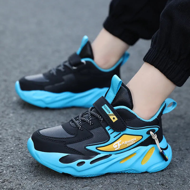 Boys' blue and black Velcro fastening sports running shoes on a white background.