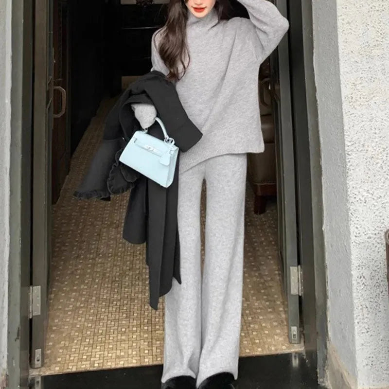 Women's casual two-piece set with long sleeve sweater and wide leg trousers in a solid colour.