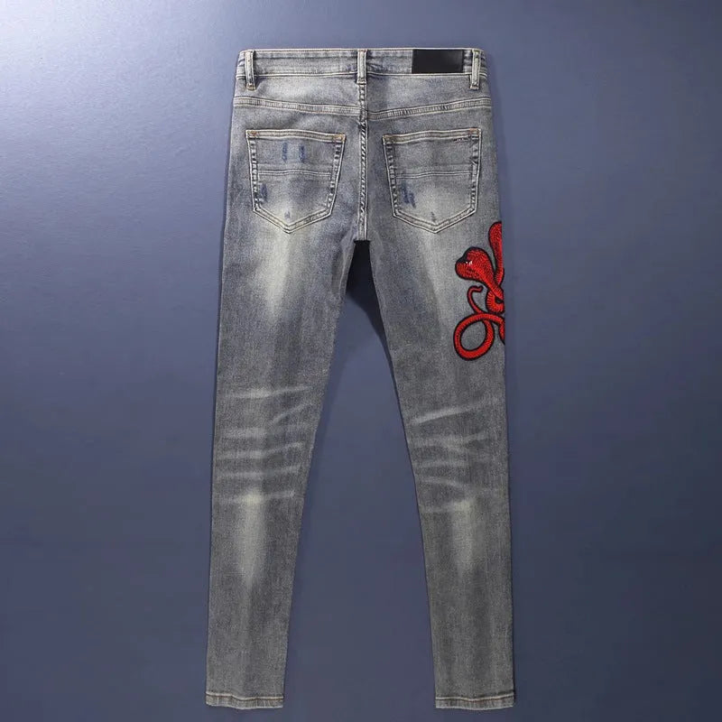 Old colour slim fit jeans with washed-out finish and embroidered hole patches