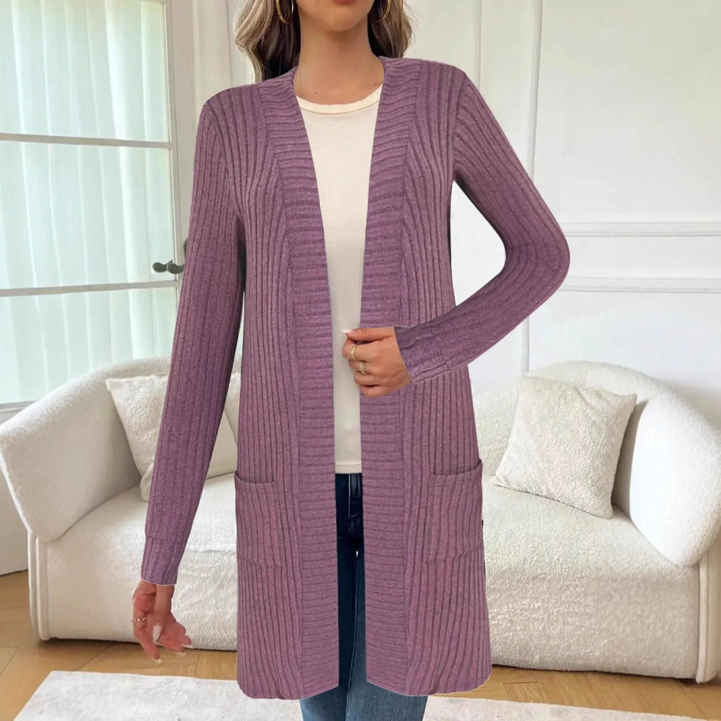 Black oversized knitted cardigan jacket with long sleeves and loose pockets.