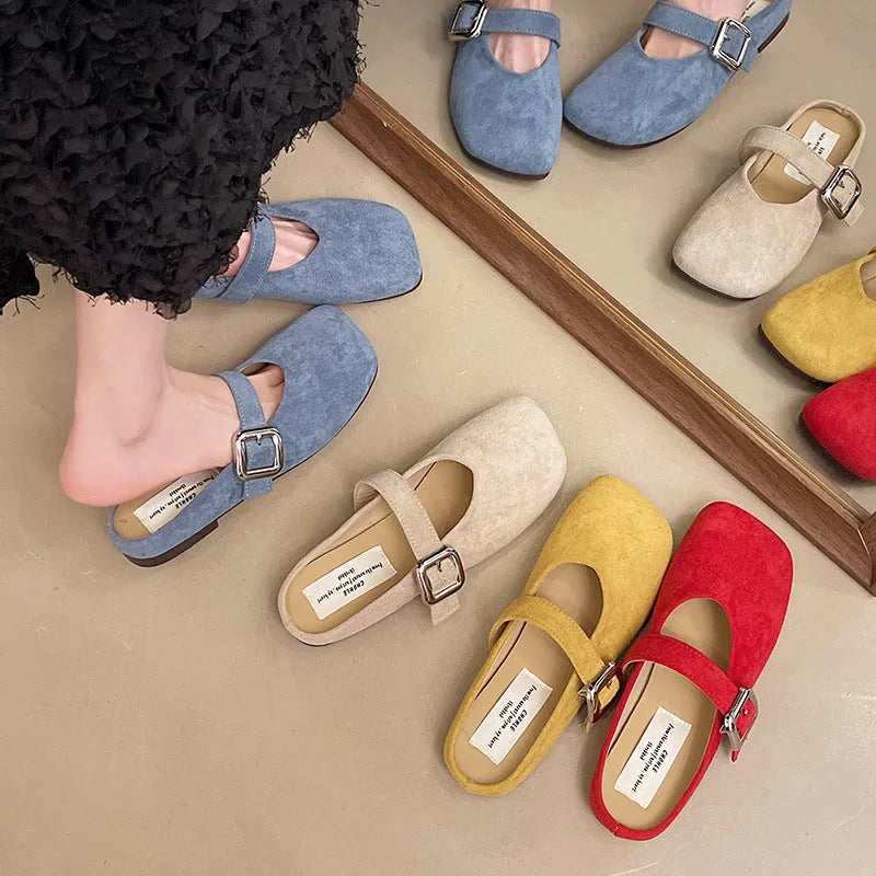 Women's flat closed toe slippers with square head in apricot, blue, red, or yellow colours on a rubber sole.