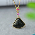 Flat Hetian gray jade pendant with copper inlay on a necklace chain.