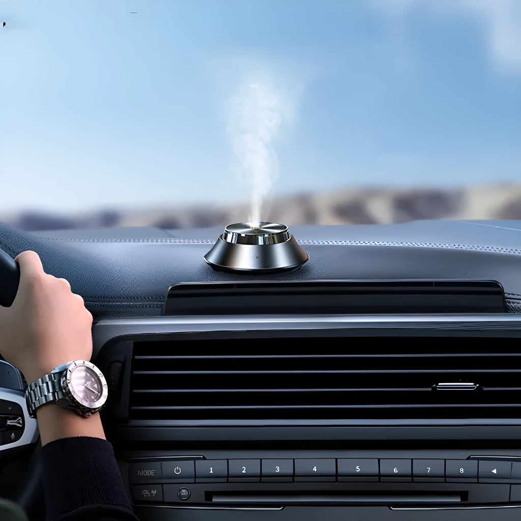 Black butterfly-shaped metal car aromatherapy diffuser with USB cable and bottle of essential oil.
