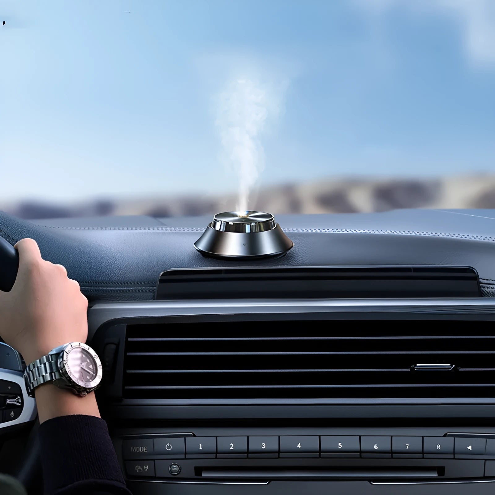 Black butterfly-shaped metal car aromatherapy diffuser with USB cable and bottle of essential oil.