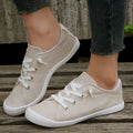 Women's creamy white casual low-top sneaker with soft fabric upper and rubber sole.