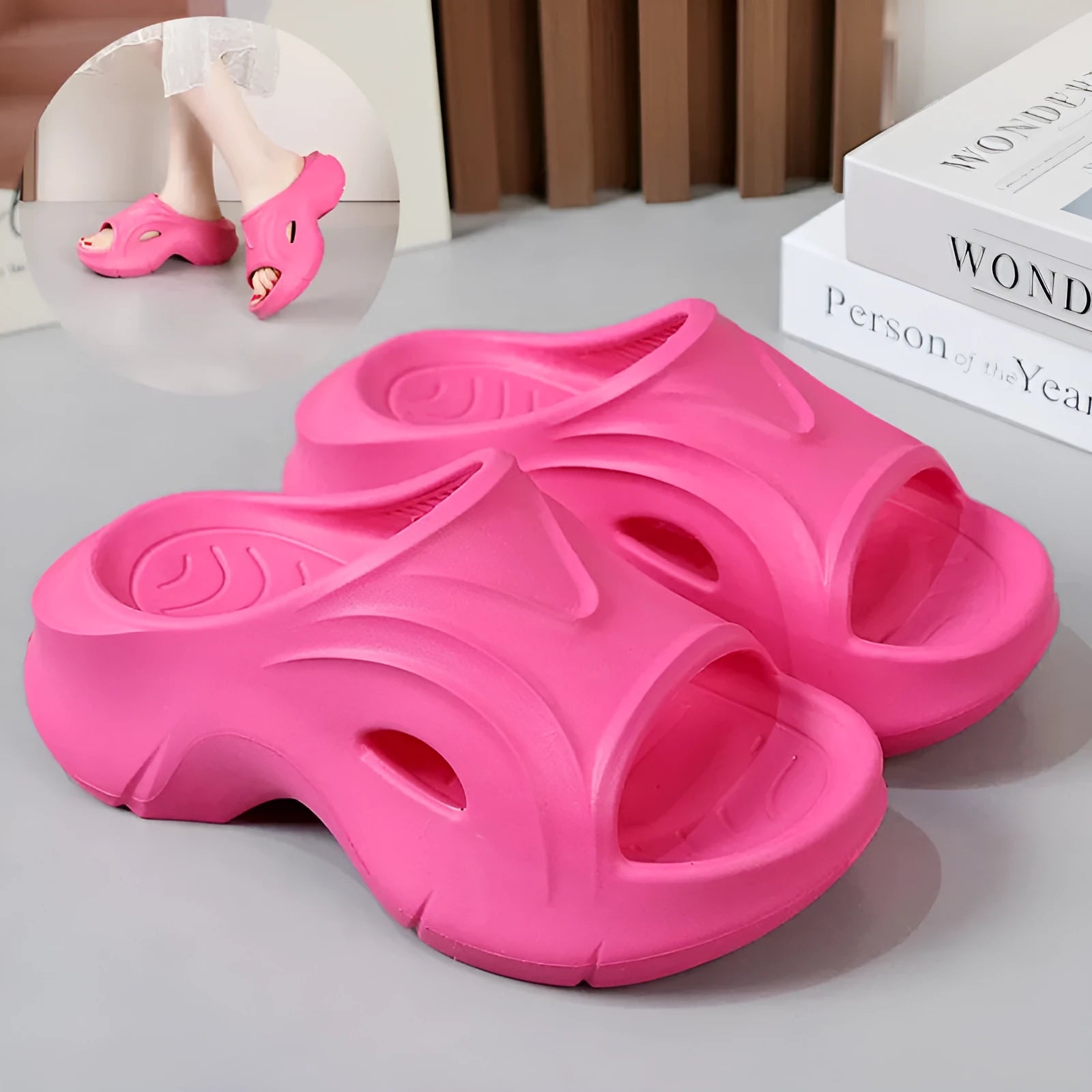 Women's white thick-soled EVA slippers with round toe on a sandy beach.