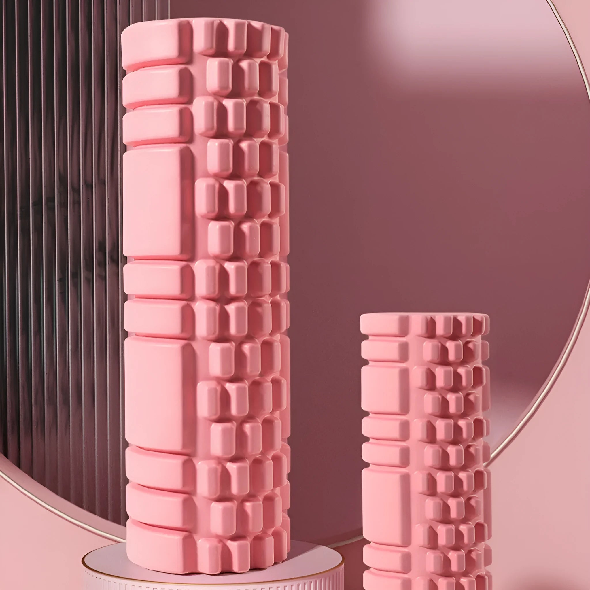EVA foam roller in choice of colours including black, grey, pink, sky blue, and light purple on a gym floor.