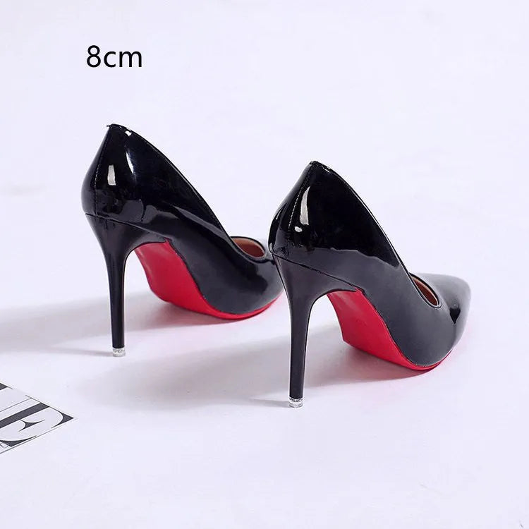 Women's black pointed toe stiletto pump with a shallow cut, shown on a white background.
