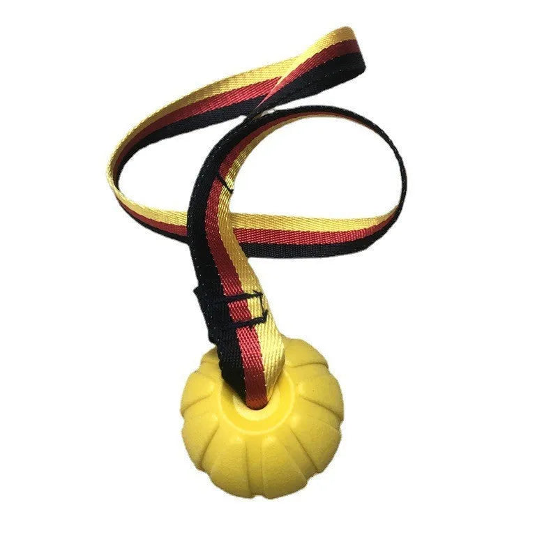 A floating EVA foam dog tetherball with a string attached, shown in camouflage colour next to a yellow one.