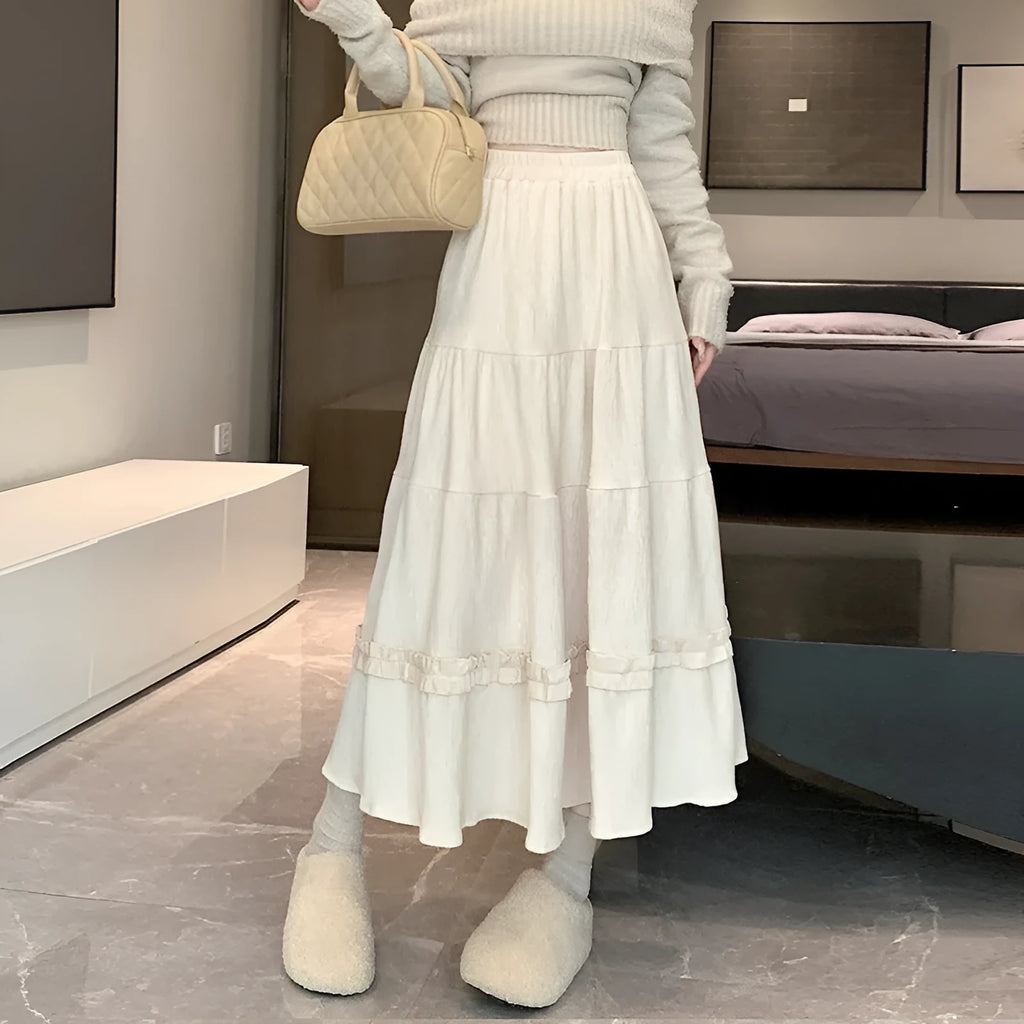 Solid colour corduroy A-line midi skirt with an elastic waistband, shown in a neutral colour.