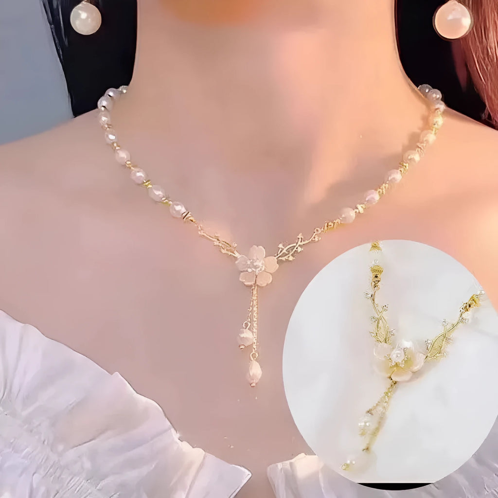 Women's alloy necklace with a white pearl flower and rose design pendant on a chain.