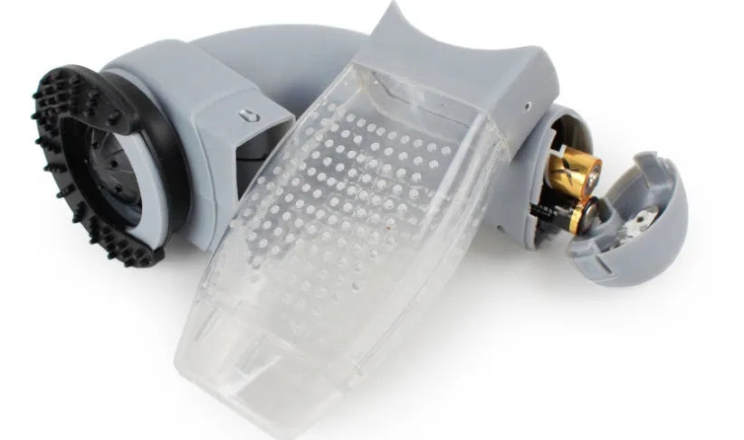 Grey portable electric pet hair remover brush with soft rubber head for grooming dogs and cats.