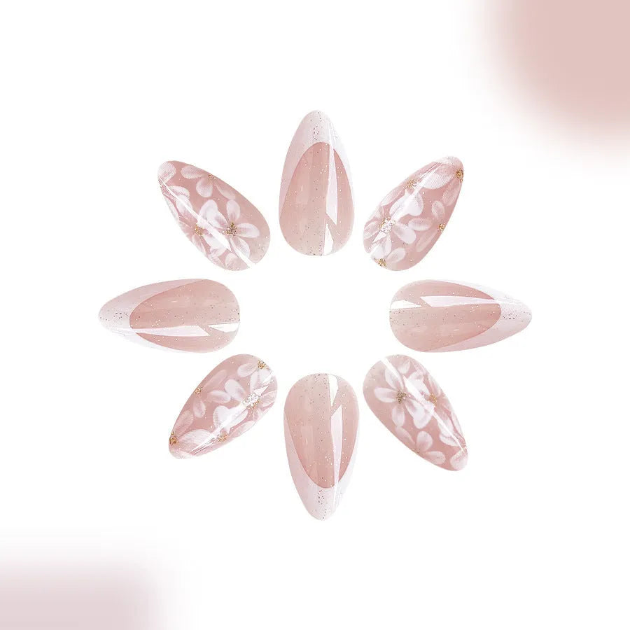 Short almond shaped French style artificial nails with glitter and flower pattern in colour C625