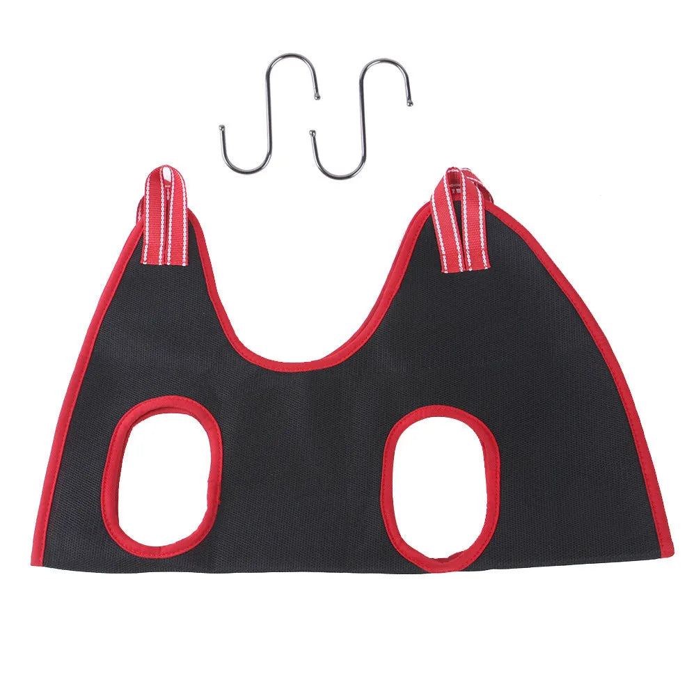 A grey pet grooming hammock restraint bag hanging from straps, with a cat inside for nail trimming, alongside grooming tools.