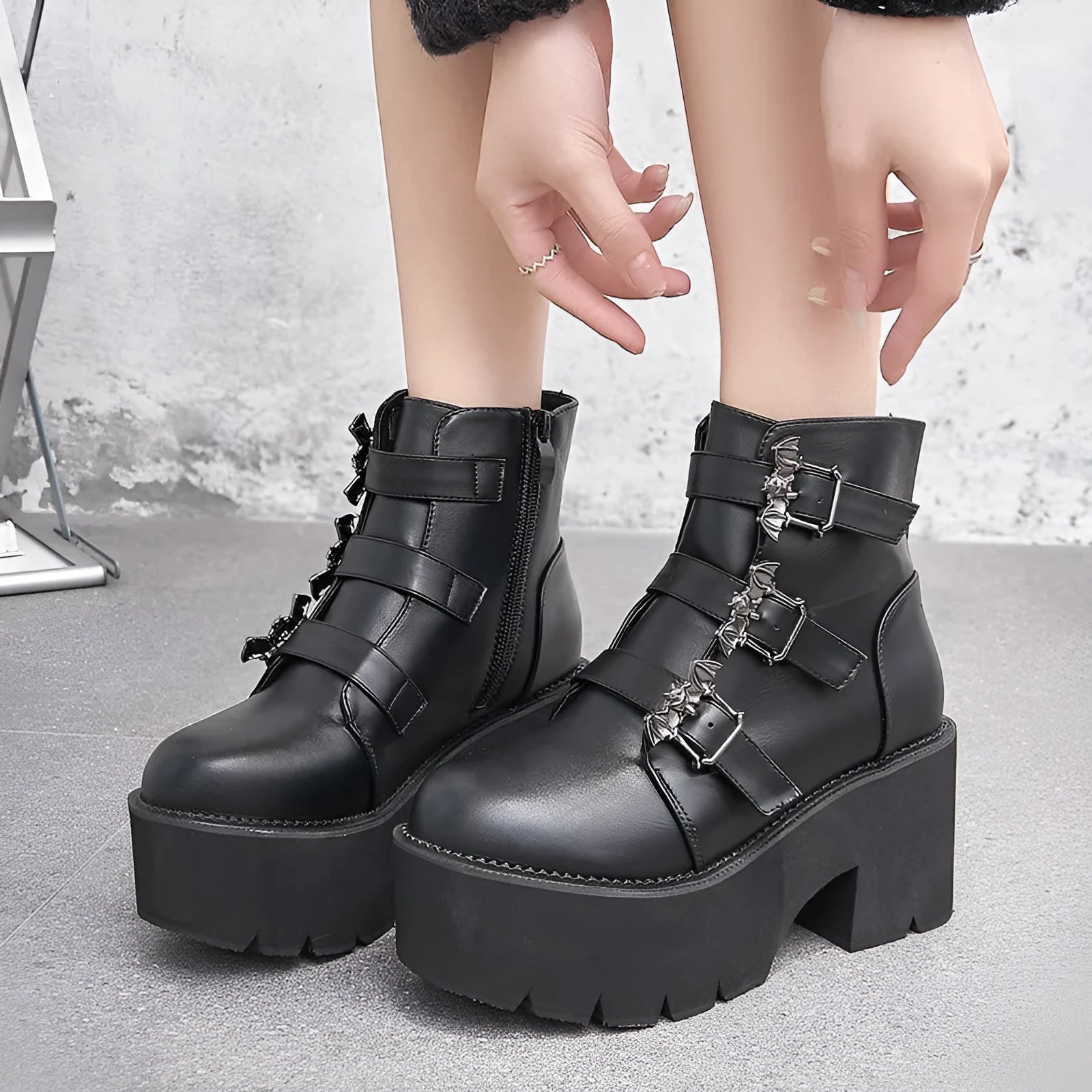 Black women's punk ankle boots with bat buckle decoration and side zip closure