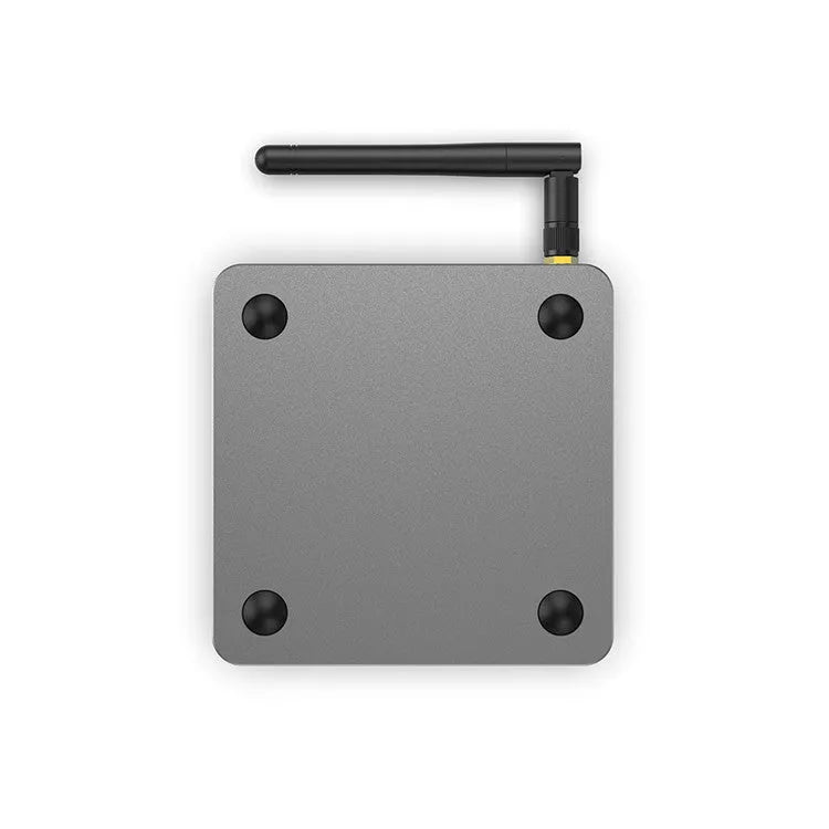 Android smart TV set-top box with remote control, HDMI cable, and power adapter on a table.