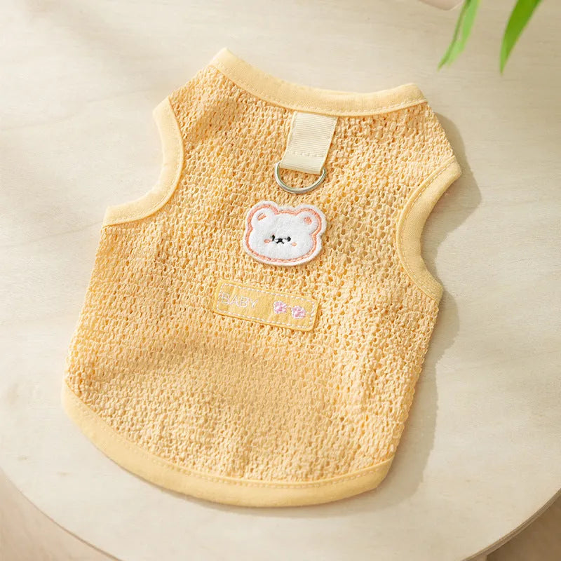 Green cat clothing with a cartoon bear patch, made from hollowed-out knitted fabric.