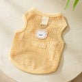 Green cat clothing with a cartoon bear patch, made from hollowed-out knitted fabric.