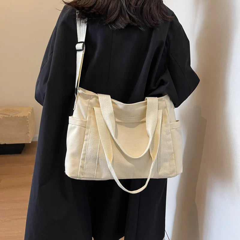 Polyester canvas shoulder bag in solid colour with internal mobile phone pocket organisation