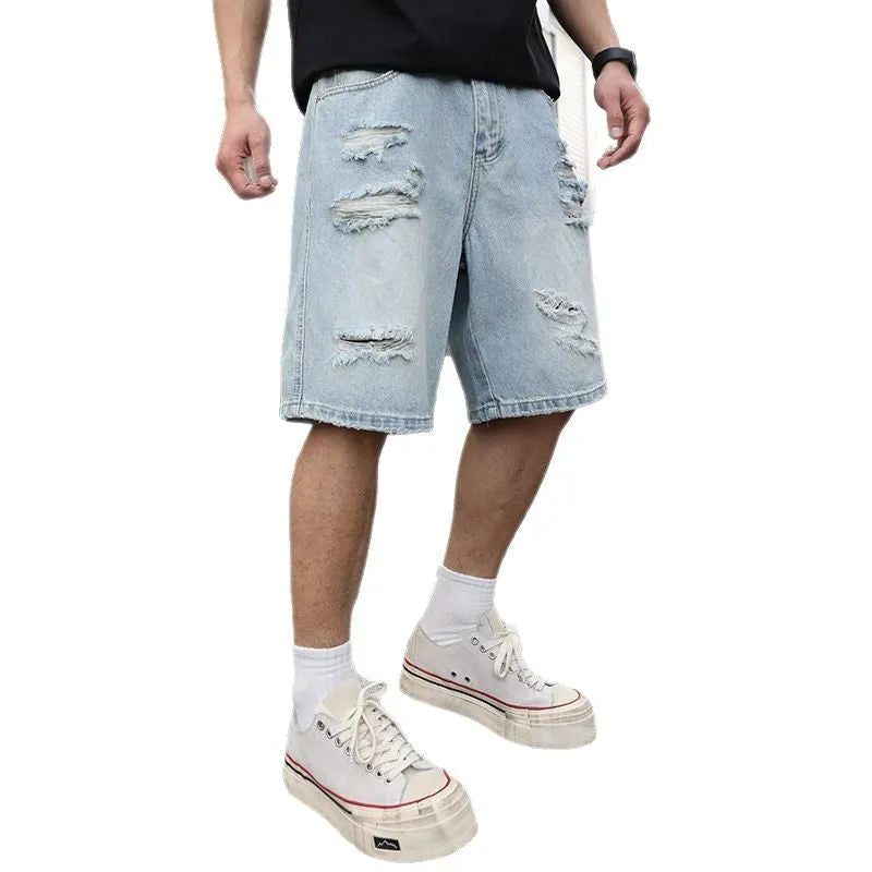 Light blue loose-fit distressed denim shorts with ripped details and straight-leg design