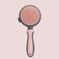 Green two-sided pet brush with slicker pins on one side and silicone massage teeth on other side