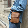 Men's brown genuine leather crossbody shoulder bag with visible sewing lines