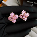 Gold plated purple oil-spot glaze flower stud earrings made from copper on a silver needle post.