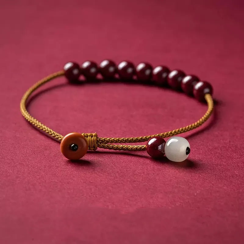 Hand-woven natural cinnabar bracelet with simple geometry shape on light background