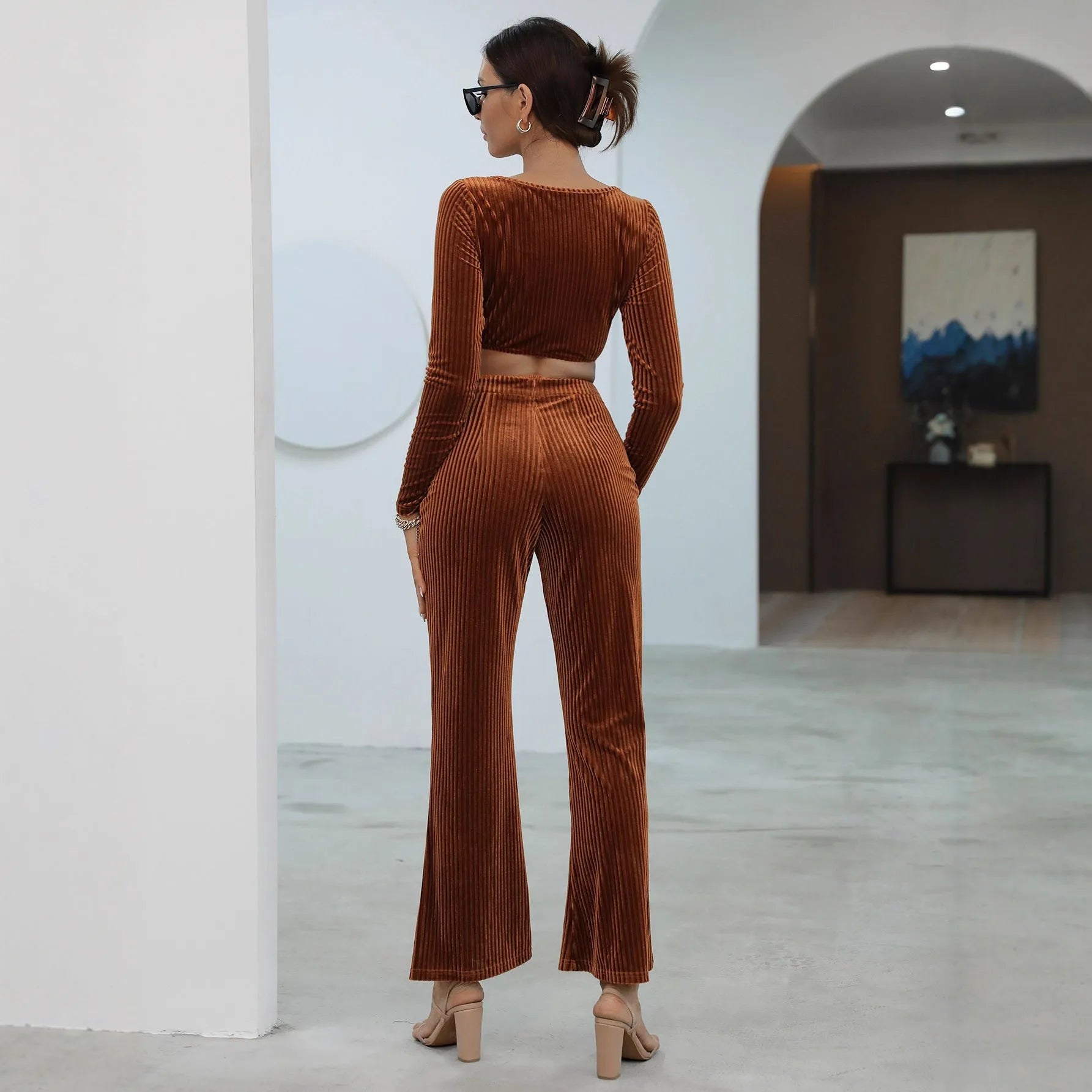 Caramel coloured long sleeve sweater and trousers casual set on a hanger.