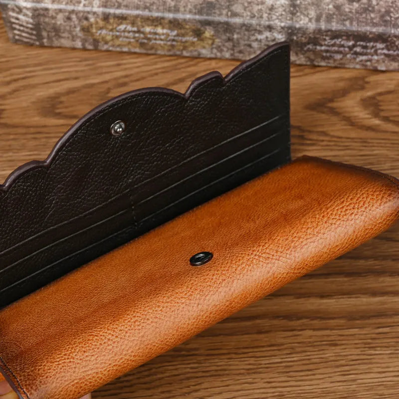 Retro brown tri-fold women's wallet with an embossed floral pattern, made from cowhide leather.