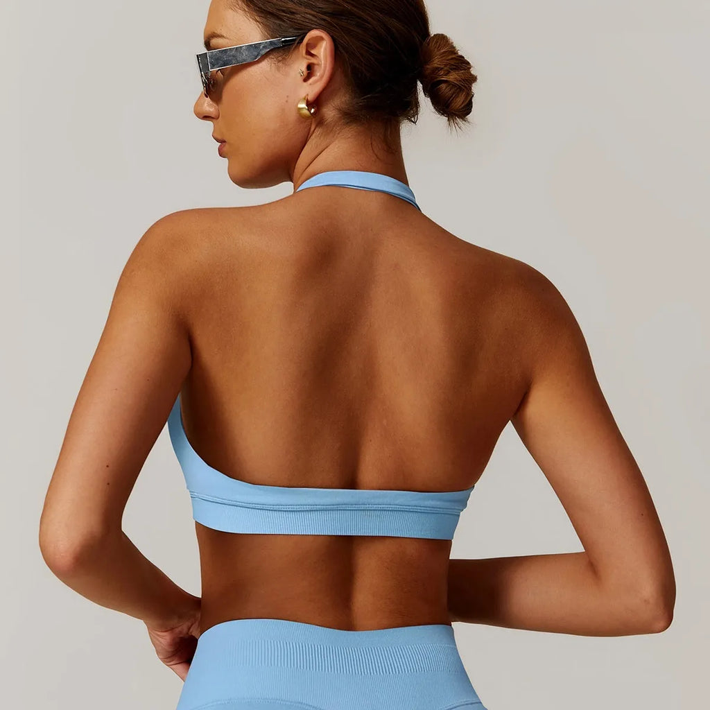 Black women's halter yoga bra with removable padding on a mannequin